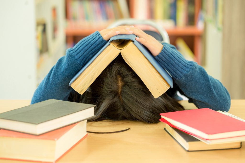 Discounts That Deliver: Affordable Tutoring for Students Who Want Results 1 portrait clever student with open book reading it college library 18 1